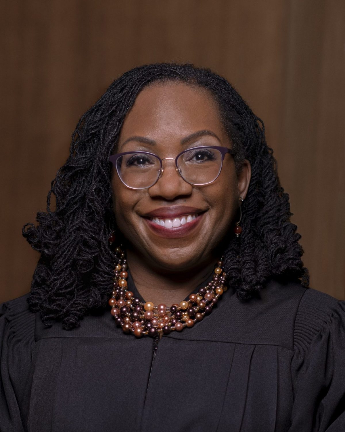Portrait of Associate Justice Ketanji Brown Jackson smiling in a black robe.